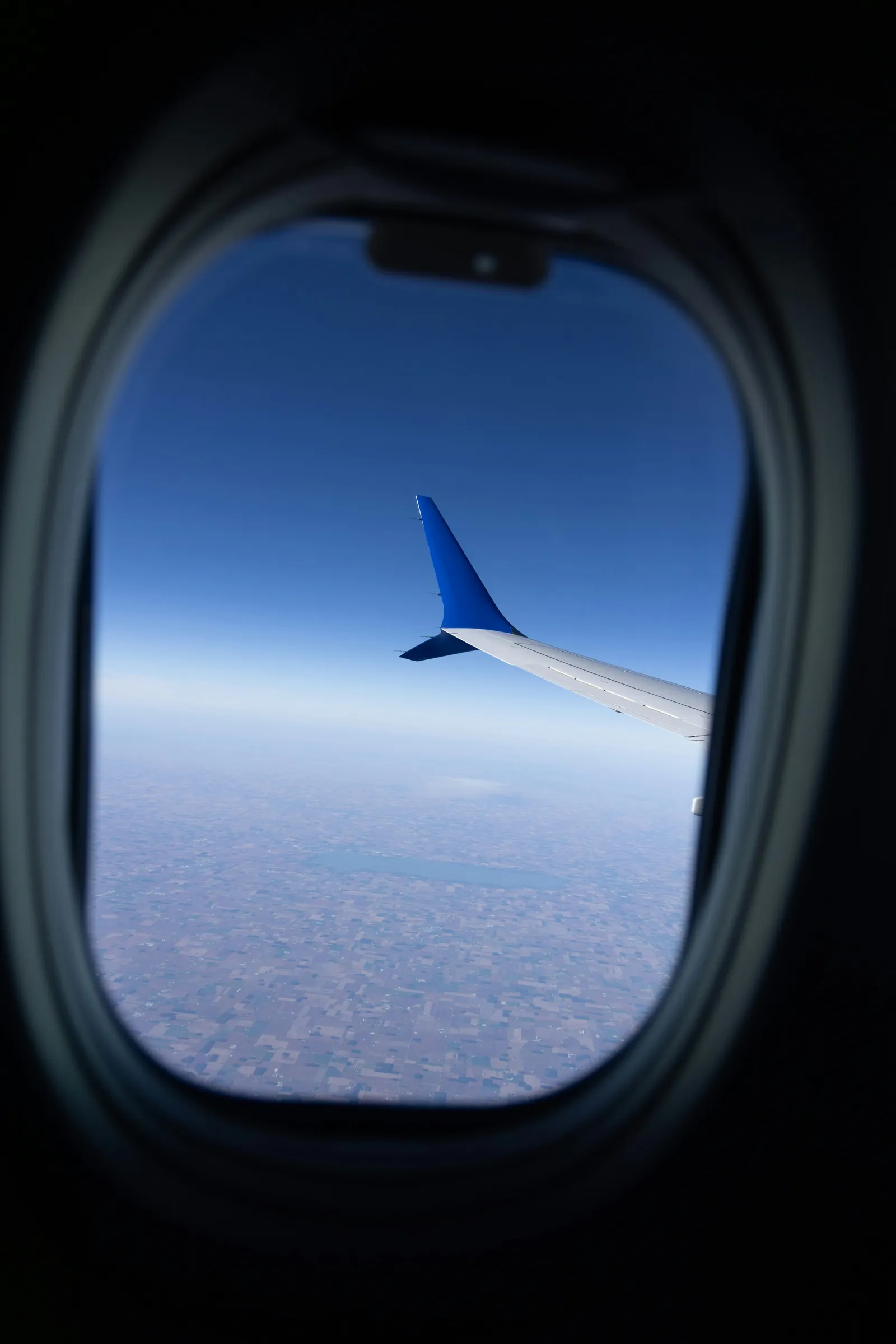 An aircraft wing above the clouds